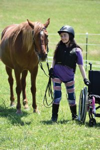 Jewell Cox standing next to her horse.