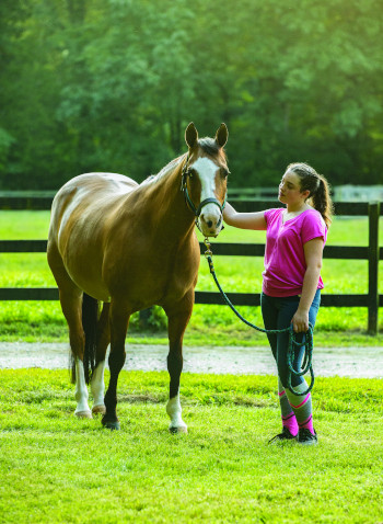 Person with horse practicing easy breathing before riding.